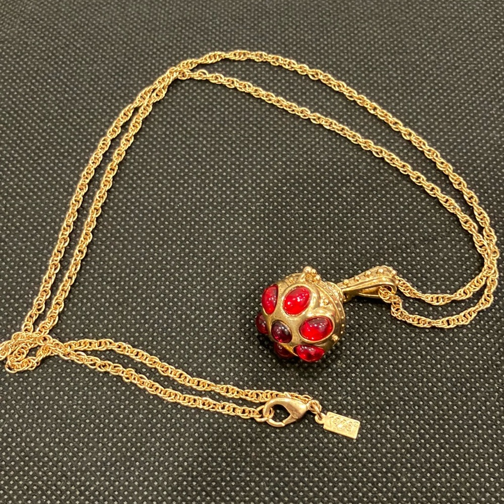 Vintage 1928 gold pocket necklace with red stones. 16 inch drop, 32 inches long.